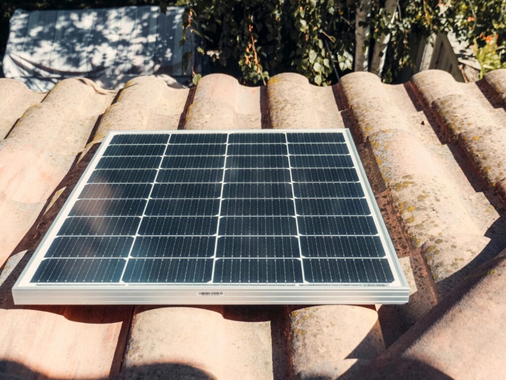 pexels-photo-9875421-9875421 A single solar panel on a rustic tiled roof gleaming in sunlight. Eco-friendly energy.